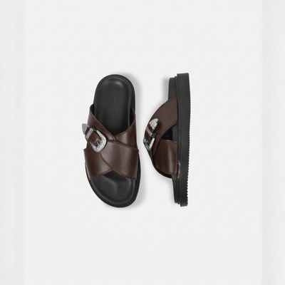 Brown sandals with a decorative buckle on a white background