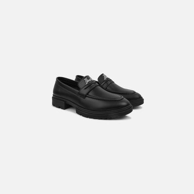 Black loafers on a white background