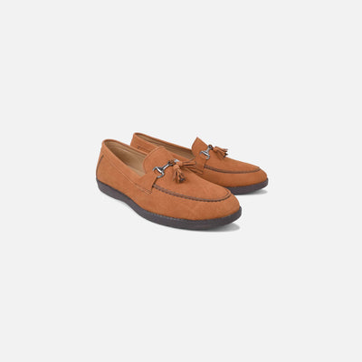 Pair of brown loafers with a tassel on a white background