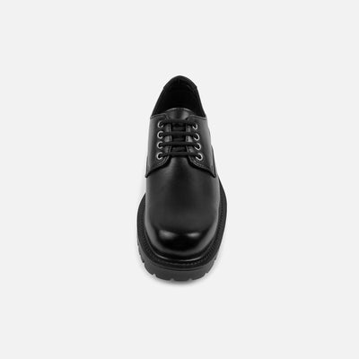 Black leather shoe on a white background