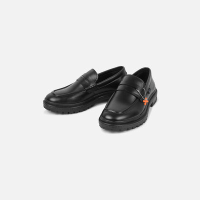 Black loafers with a small orange logo on a light gray background