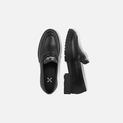 Black slip-on shoes with a brand logo on a white background