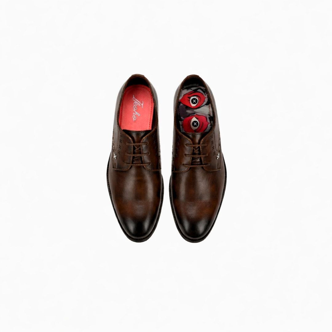Pair of brown dress shoes with red lining on a white background