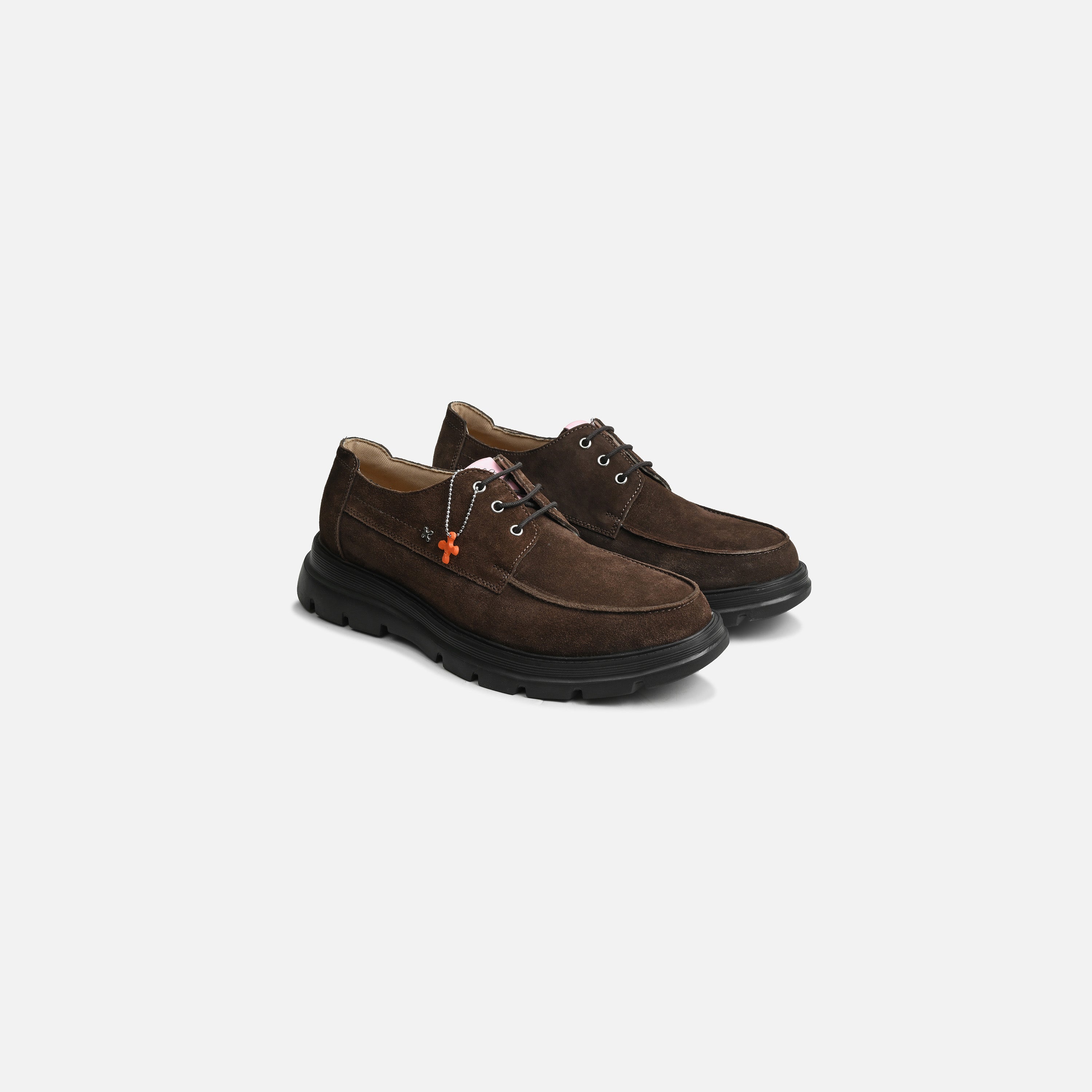 A pair of dark brown suede lace-up shoes with black soles, displayed on a clean light gray background.