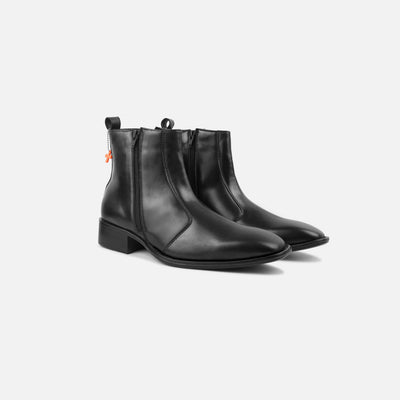 Pair of black leather ankle boots on a white background