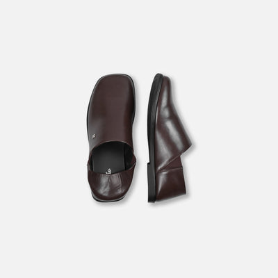 Brown leather shoes on a light gray background