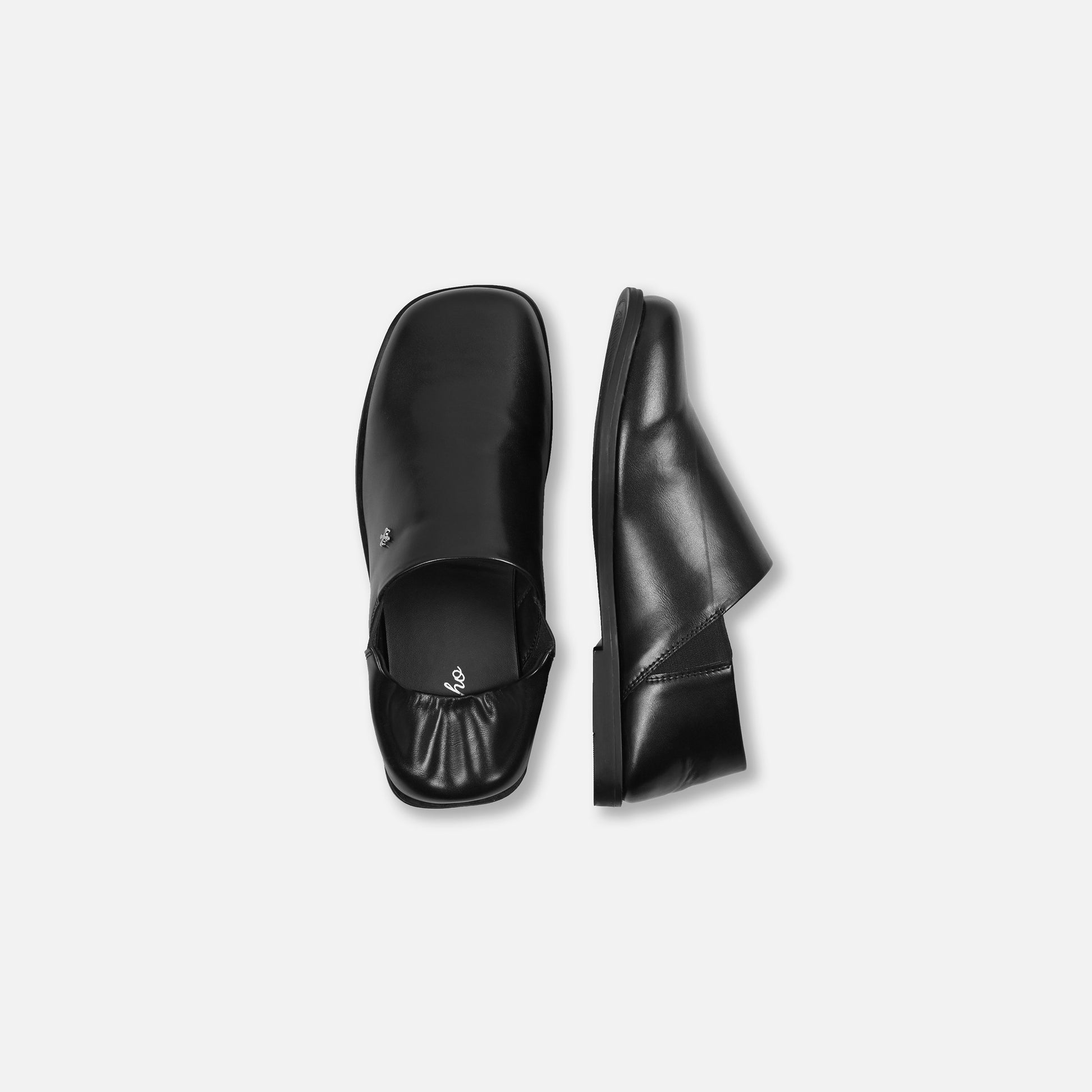 Black leather shoes on a light gray background