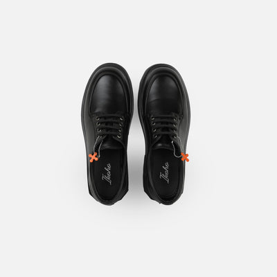 Pair of black shoes with orange accents on a white background