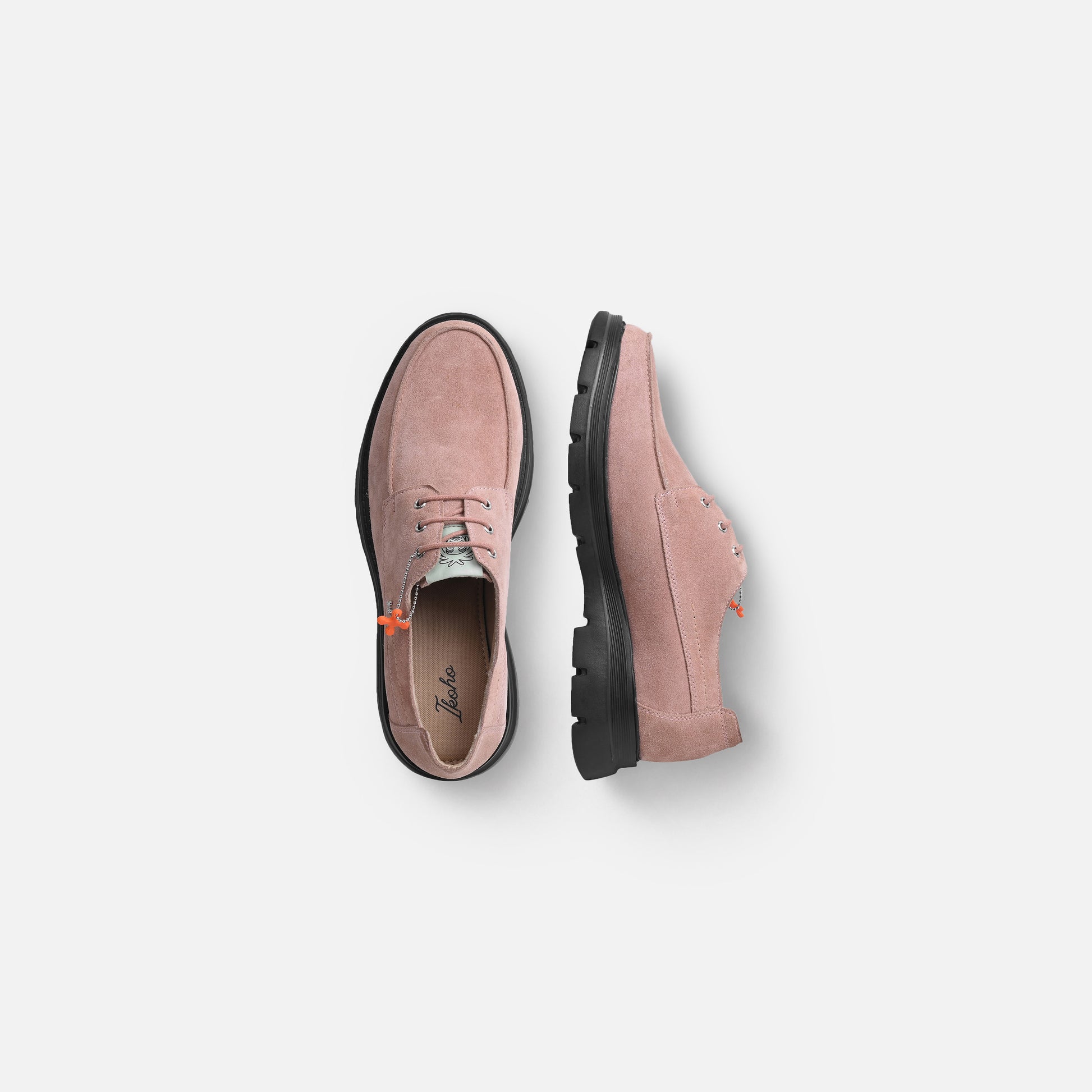 A pair of dusty pink suede lace-up shoes shown from top and side views against a light gray background.