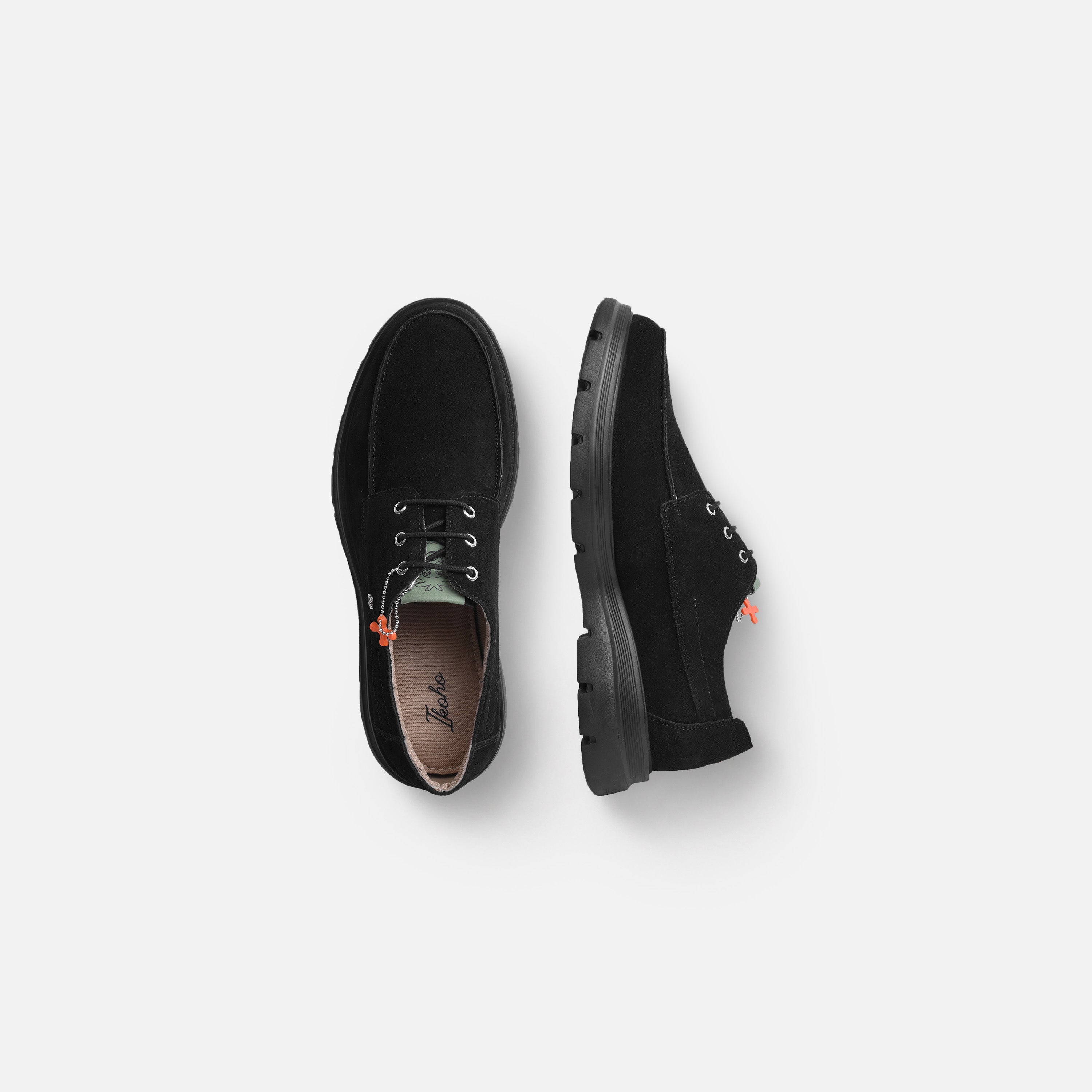 A pair of black suede lace-up shoes shown from top and side views on a light gray background.
