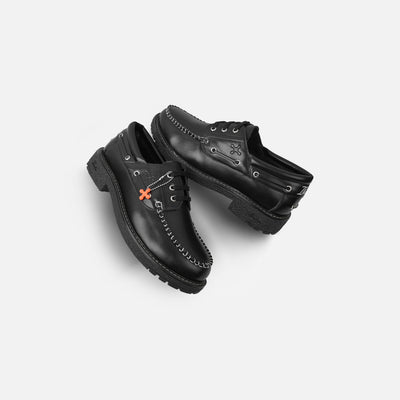 Pair of black leather shoes on a light gray background