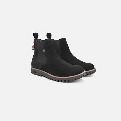 Black Chelsea boots on a white background