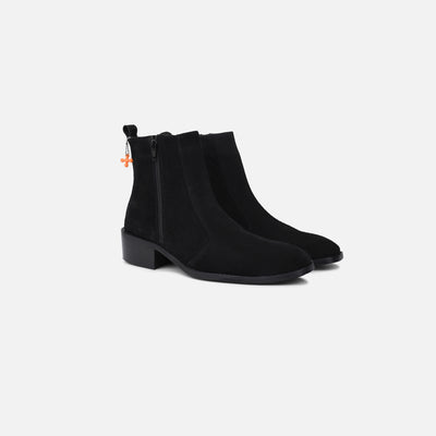 Black ankle boots on a light gray background