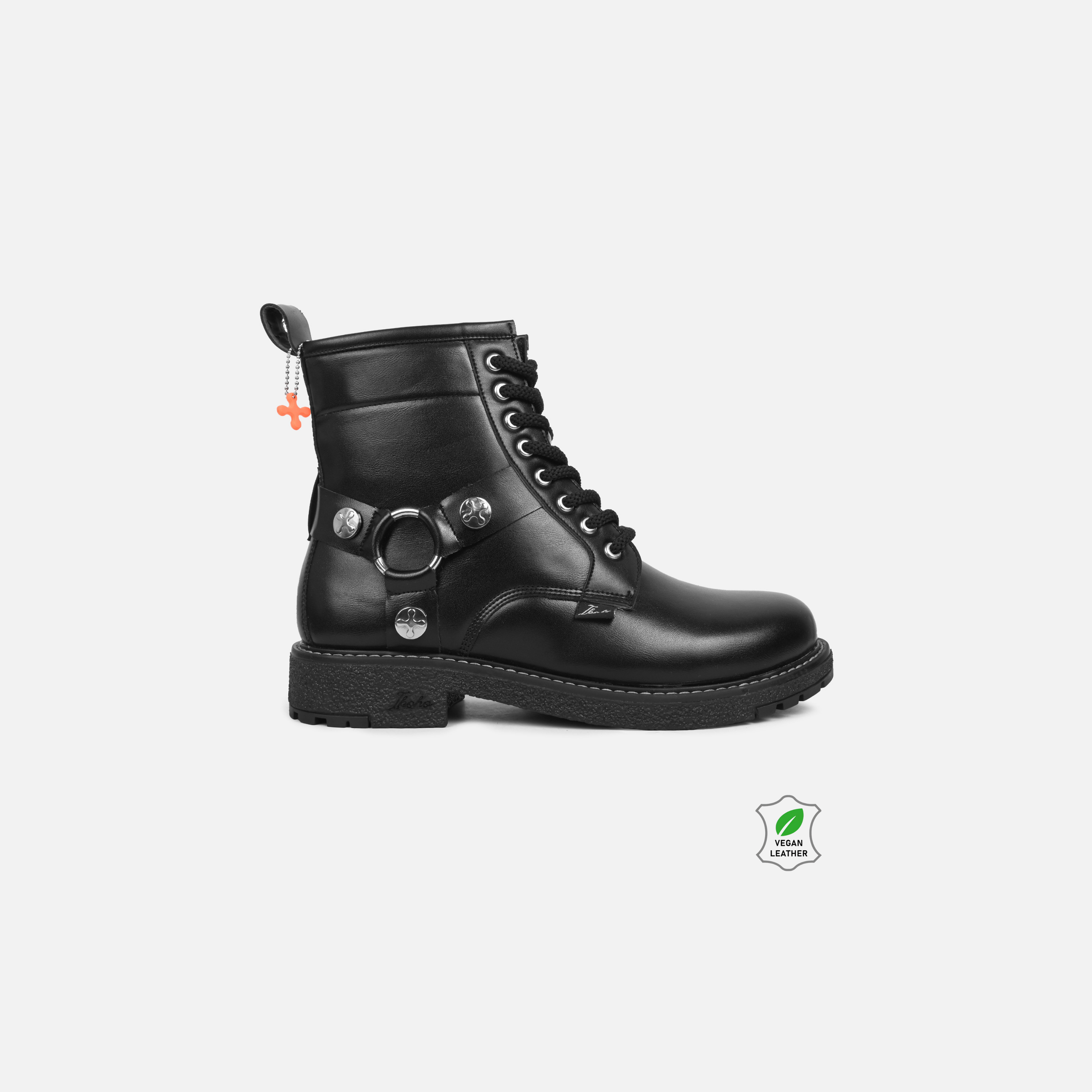 Black leather boot with metallic details on a white background