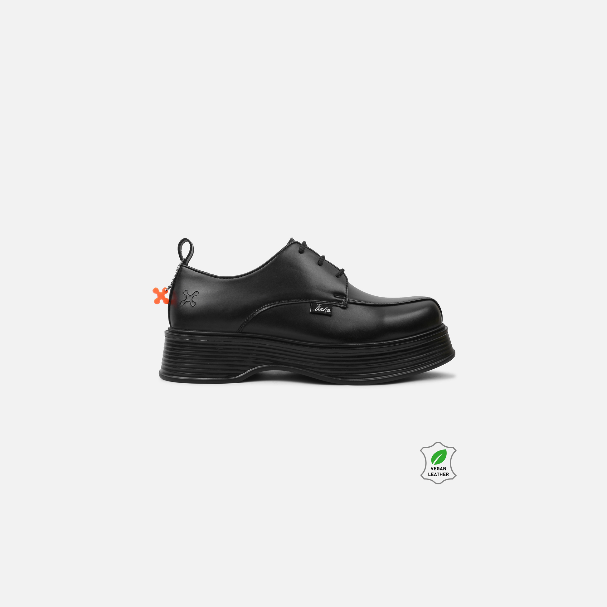 Black leather shoe on a white background with brand logos.