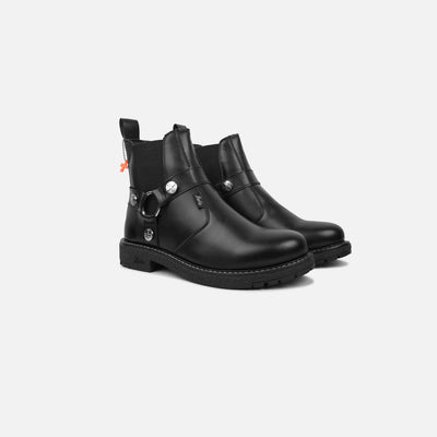 Pair of black leather boots with decorative elements on a white background