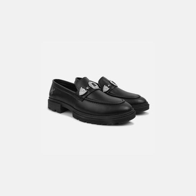Pair of black loafers with heart designs on a white background
